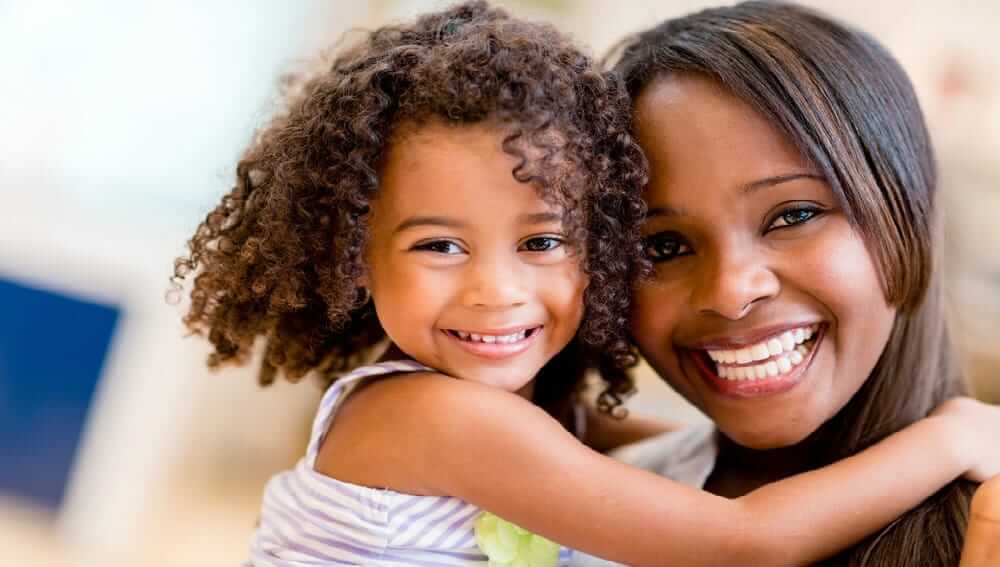 Picture of woman and child hugging and smiling at the camera