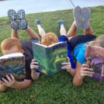 Picture of three primary-aged children reading
