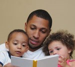 Picture of father reading to two young children