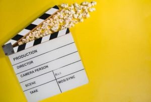 Picture of a film clapperboard with popcorn